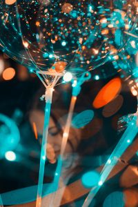 Colorful bokeh effect with balloons and party lights creating a festive atmosphere.